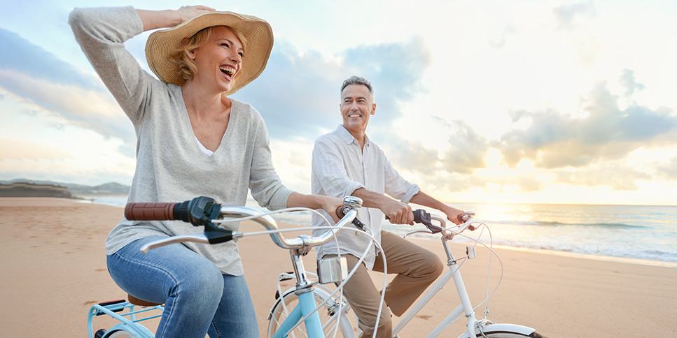 Couple cycling at the beach