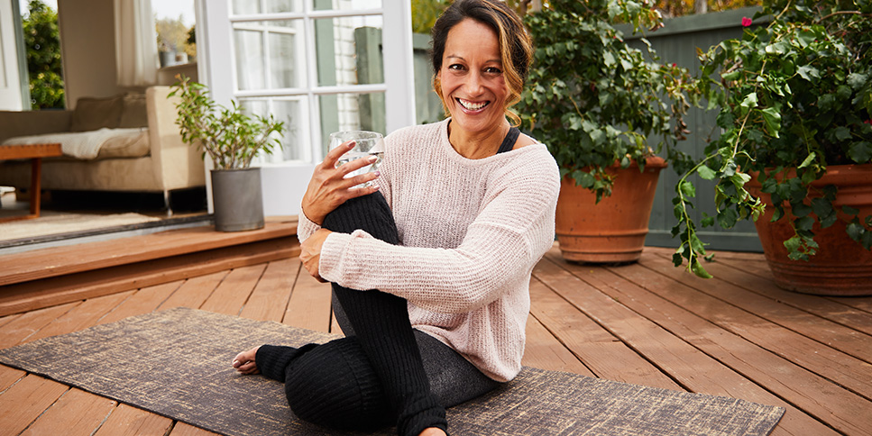 Smiling mature woman sitting on her patio at home